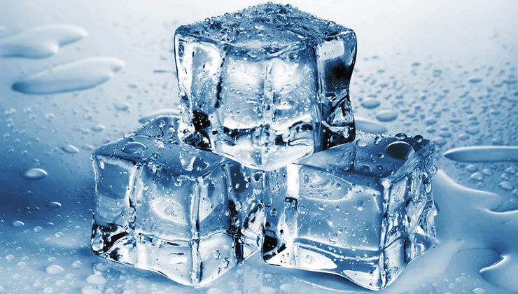three ice cubes sitting on top of a table.