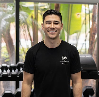 a man standing in front of a gym machine.