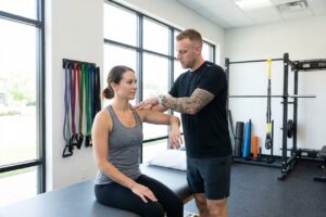 Patient working with a provider at a sports physical therapy clinic in Torrance, CA during a one-on-one orthopedic shoulder assessment